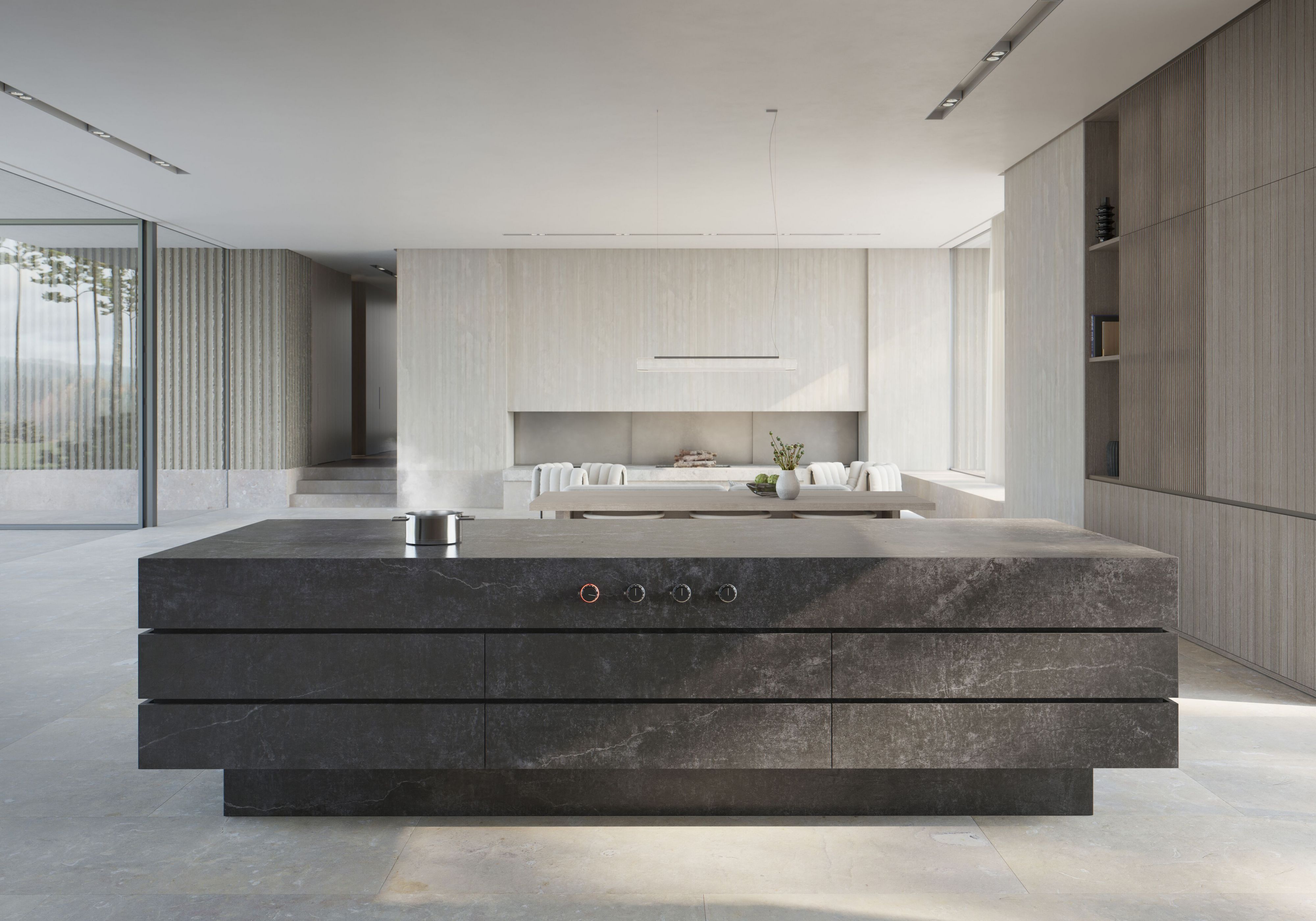 Gaggenau Kücheninsel mit großzügiger Arbeitsfläche in reduzierter Raumarchitektur Kücheninsel aus dunklem Steinmaterial vor heller Wand in moderner, offener Küche von Gaggenau
